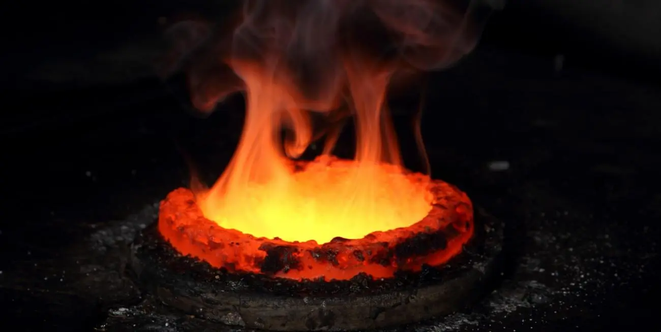 Molten gold glowing in a crucible at the Gold Bank refinery