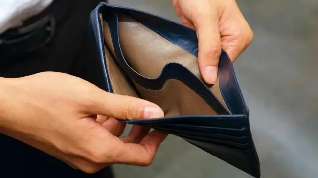 Hands opening an empty leather wallet